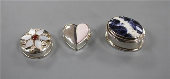 Three assorted modern silver pill boxes, including oval with hardstone lid, heart shaped and circular with shell inset lid, largest 4cm